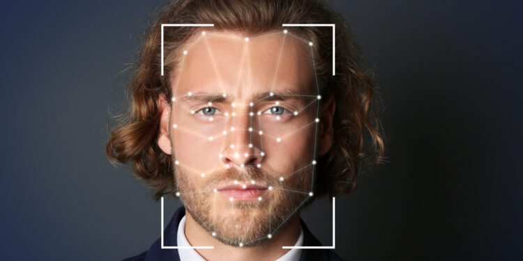 facial recognition businessman with scanner frame and digital biometric grid on dark background 750x375