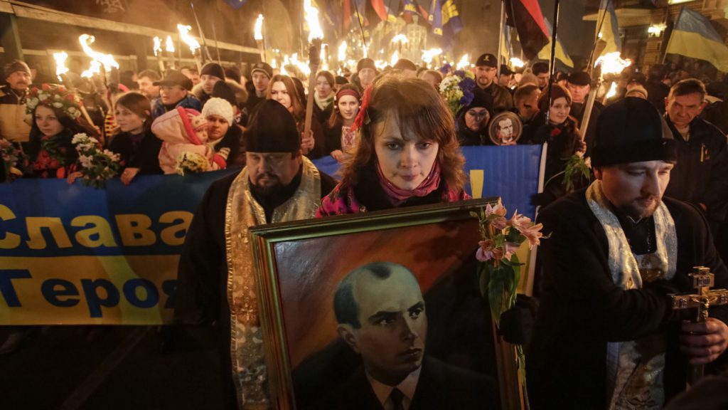 activists of the svoboda (freedom) ukrainian nationalist party hold torches as they take part in a rally to mark the 105th year since the birth of stepan bandera in kiev